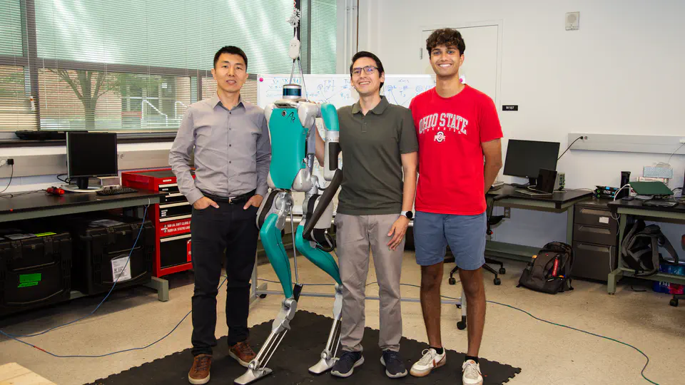 Researchers with Digit in the Cyberbotics Lab.